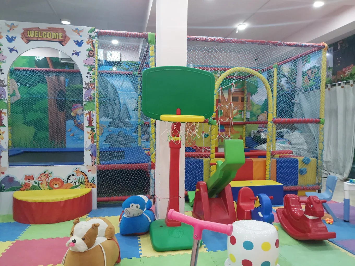 Kids activity area with basketball hoop and seesaw